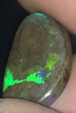 Freeform matrix opal with subtle flashes of red, green and purple