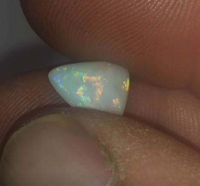 Green, gold and orange in this triangle cut opal