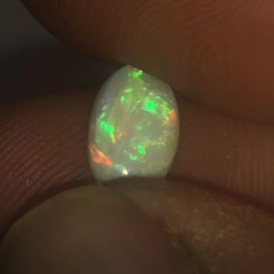 Bright green, orange and red oval cut opal