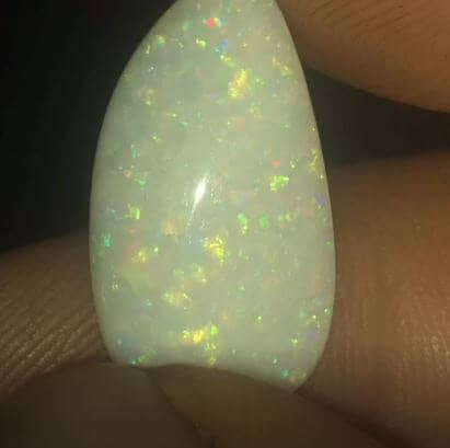 Large Coober Pedy opal showing green and orange pin fire pattern