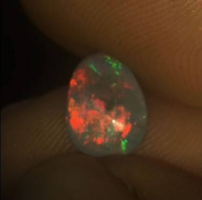 Brilliant neon red colour in this dark opal