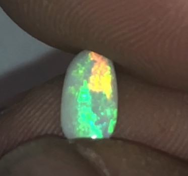 Bright orange, gold and green oblong shaped Coober Pedy opal