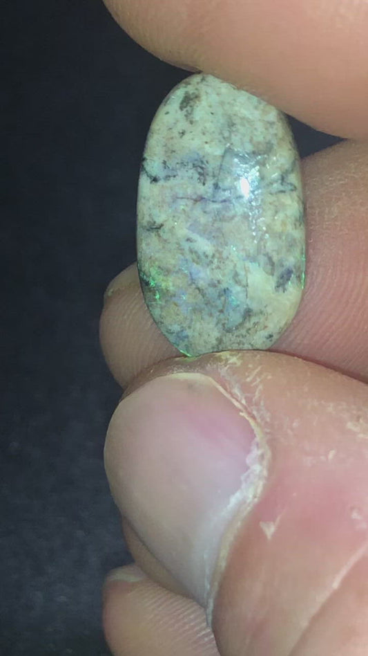 Green and purple opal matrix on an earthy background