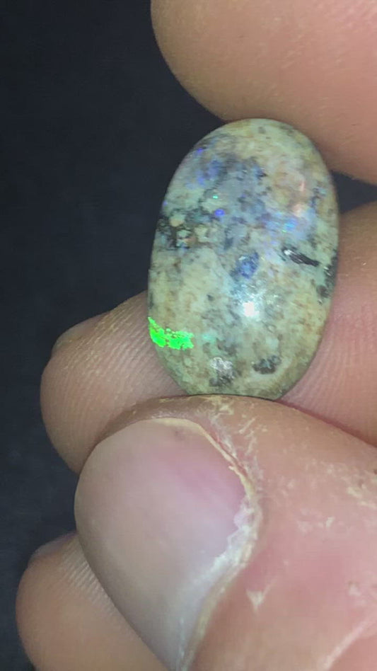 Green and purple matrix opal in a marble looking background