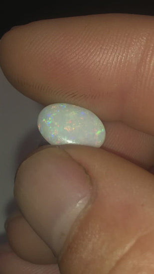 Green purple and red pinfire in this opal