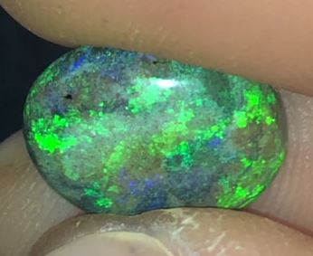 Gorgeous floral pattern of green in this oval shaped matrix opal