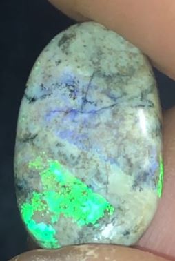 Green and purple opal matrix on an earthy background