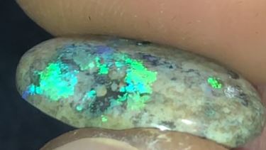 Green and purple matrix opal in a marble looking background