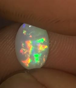 Very bright multicolored oval opal gem