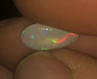 Flashes of green and red in this teardrop opal