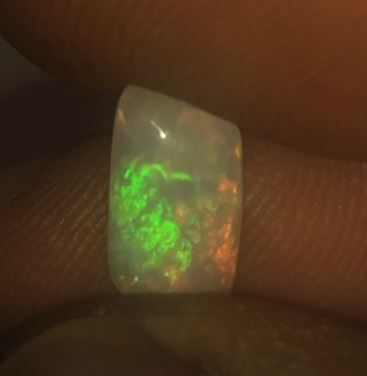 Green, burnt orange and a hint of red in this crystal opal