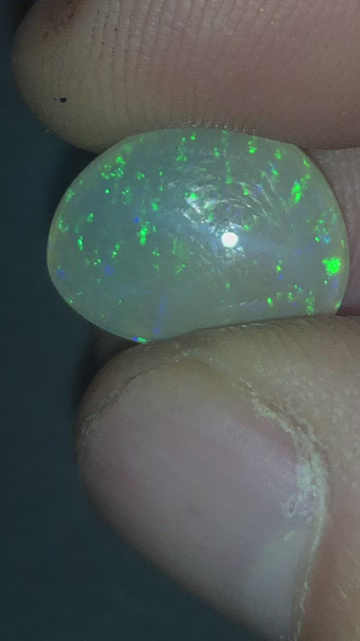 Green pinfire in a honey toned semi-crystal opal