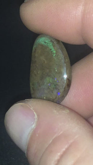 Freeform matrix opal with subtle flashes of red, green and purple