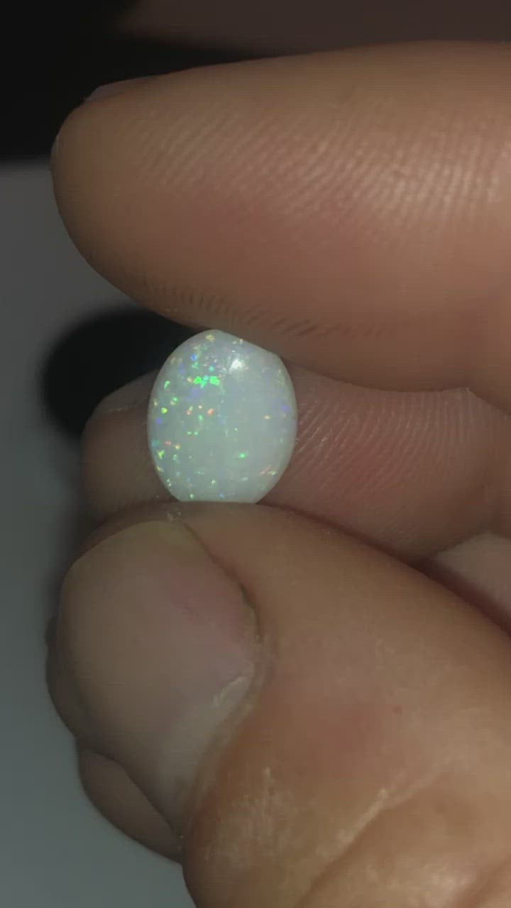 Green purple and red pinfire in this opal