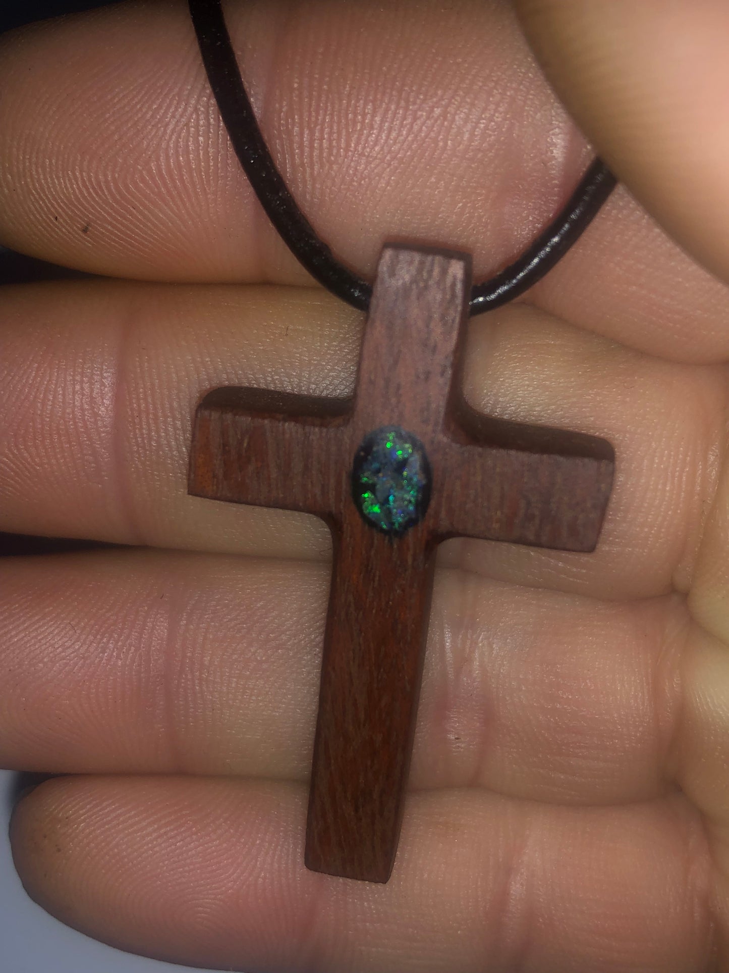 Wooden cross pendant inlaid with opal chips