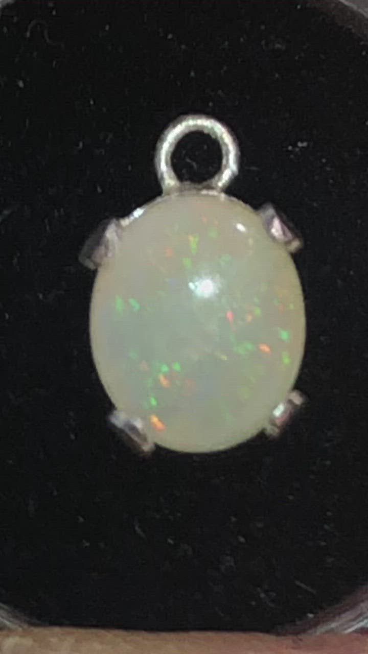 Red and green solid opal set in a silver pendant