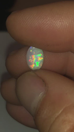 Very bright multicolored oval opal gem